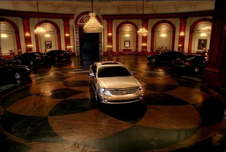 2005_STS_GMCadillacSTSgrab03.jpg - [de]2004 STS TV-Spot[en]A Cadillac STS takes a spin around the ballroom, leaving other prestige luxury vehicles in its wake, during the all-new STS advetising campaign which begins airing Friday, September 17, 2004 during the Ryder Cup. With the new spot titled "Party Crashers," Cadillac is taking its most aggressive approach to help consumers position the 2005 STS among its competitors. During the spot, set in a grand ballroom, the STS races in with engine roaring to Led Zepplin's familiar "Rock and Roll." Surprised, the other cars, which had been dancing to classical music, slip out of the way, leaving the STS to stand alone in the spotlight. (General Motors/Handout)