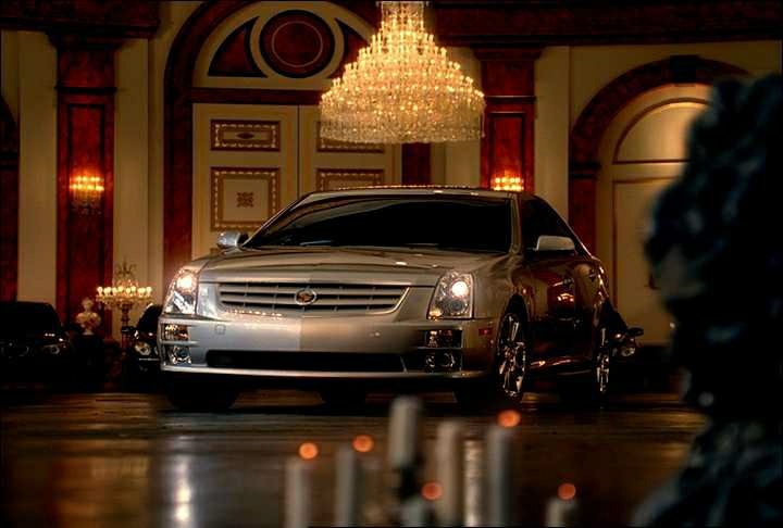 2005_STS_GMCadillacSTSgrab04.jpg - [de]2004 STS TV-Spot[en]A Cadillac STS takes a spin around the ballroom, leaving other prestige luxury vehicles in its wake, during the all-new STS advetising campaign which begins airing Friday, September 17, 2004 during the Ryder Cup. With the new spot titled "Party Crashers," Cadillac is taking its most aggressive approach to help consumers position the 2005 STS among its competitors. During the spot, set in a grand ballroom, the STS races in with engine roaring to Led Zepplin's familiar "Rock and Roll." Surprised, the other cars, which had been dancing to classical music, slip out of the way, leaving the STS to stand alone in the spotlight. (General Motors/Handout)